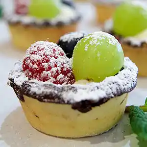 Mürbteigförmchen mit Crème-Chantilly und Obst.